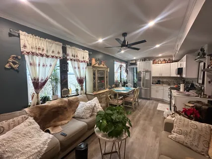 a kitchen with stainless steel appliances granite countertop a refrigerator sink and stove