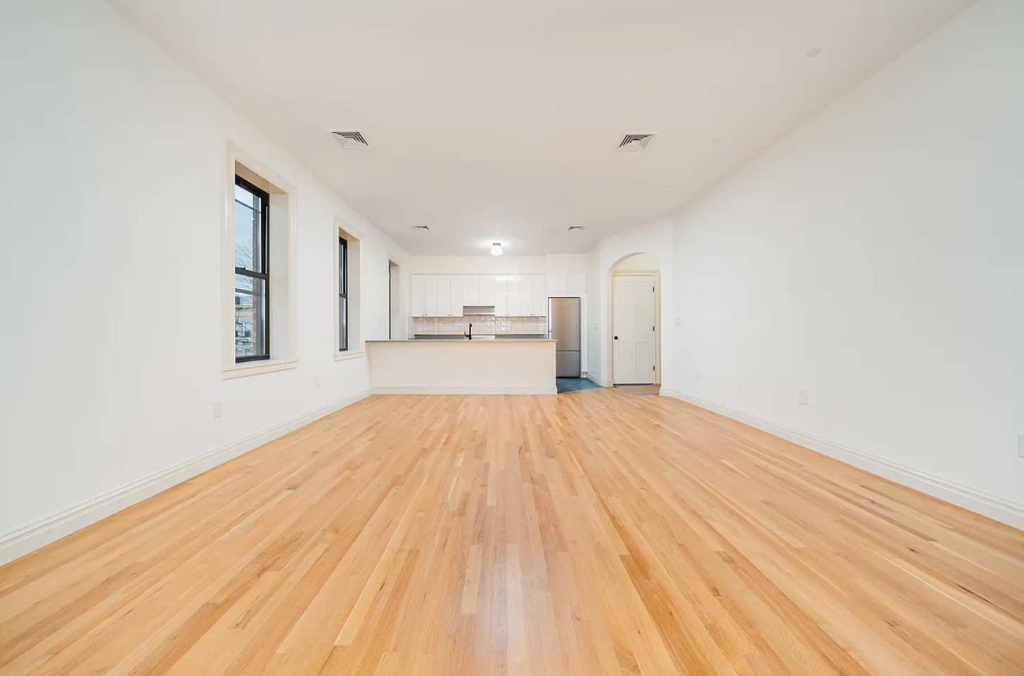 68-38 Forest Avenue, Unit 3R Queens, NY 11385 - Photo 3 of 15 a view of empty room with wooden floor and window