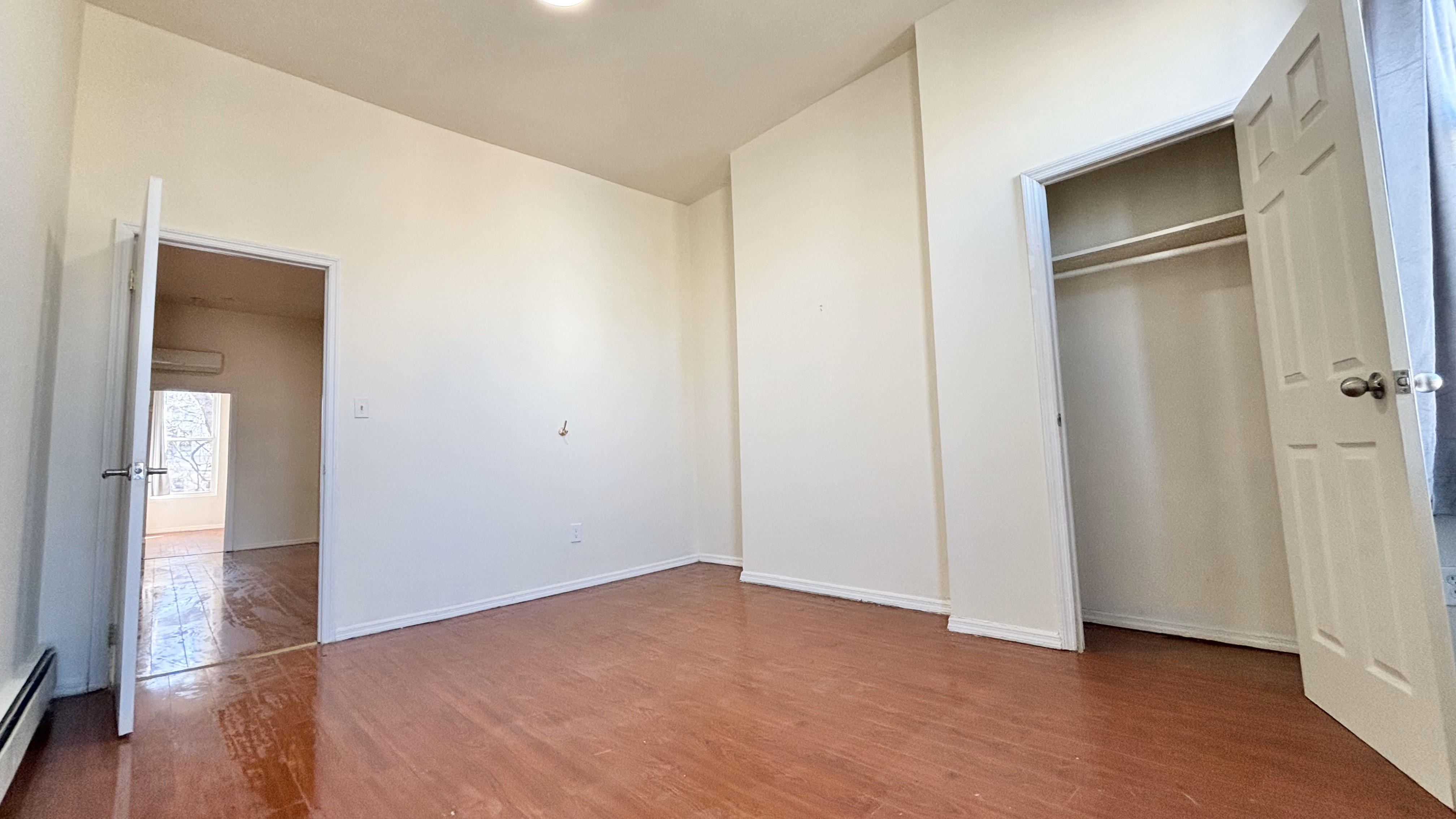 74 Himrod Street, Unit 2 Brooklyn, NY 11221 - Photo 11 of 16 a view of an empty room with wooden floor