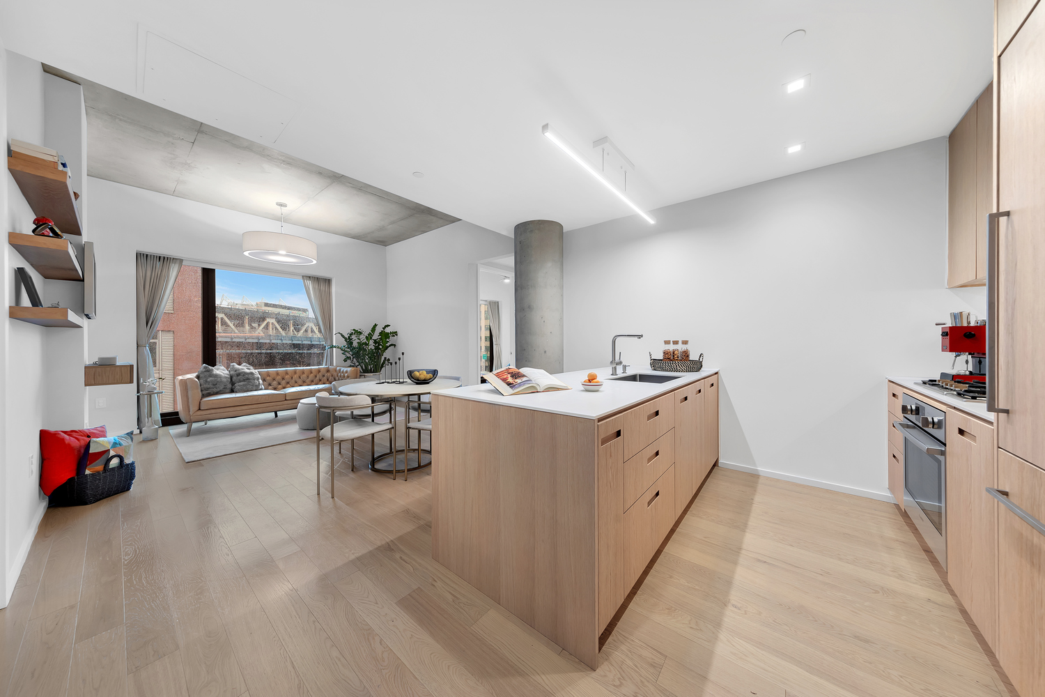 a kitchen with sink cabinets and living room view