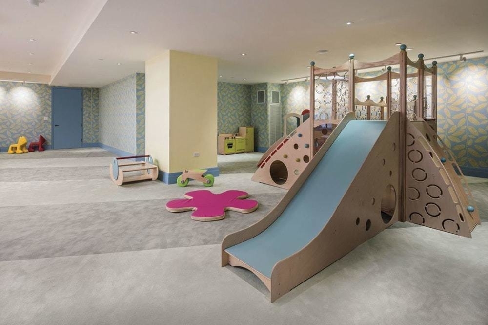 100 Barclay Street, Unit 13G Manhattan, NY 10007 - Photo 14 of 26 a bedroom with furniture and a chandelier