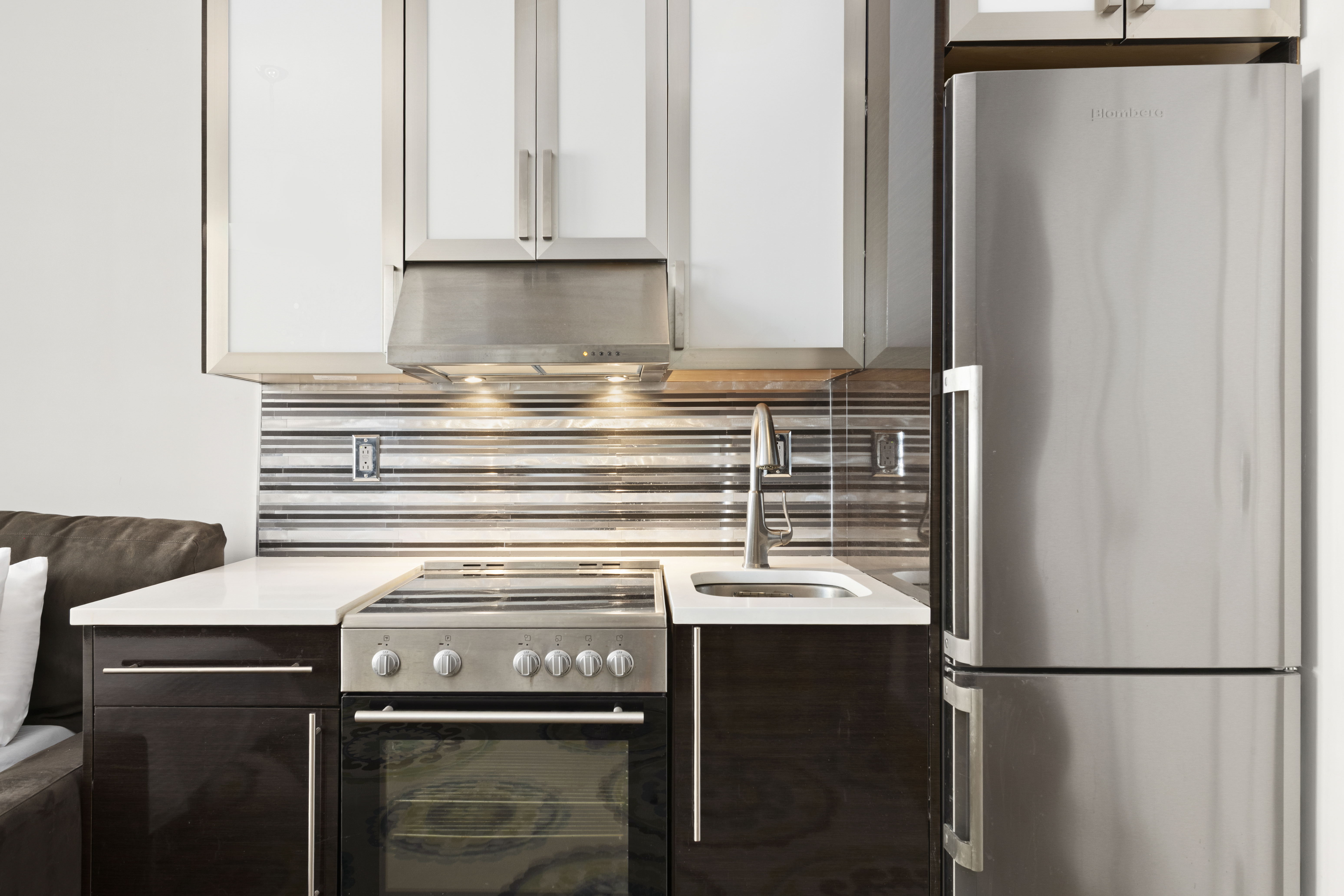 20 West 72nd Street, Unit 1600 Manhattan, NY 10023 - Photo 3 of 7 a kitchen with a refrigerator and cabinets