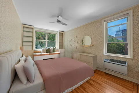 a bedroom with a bed and window