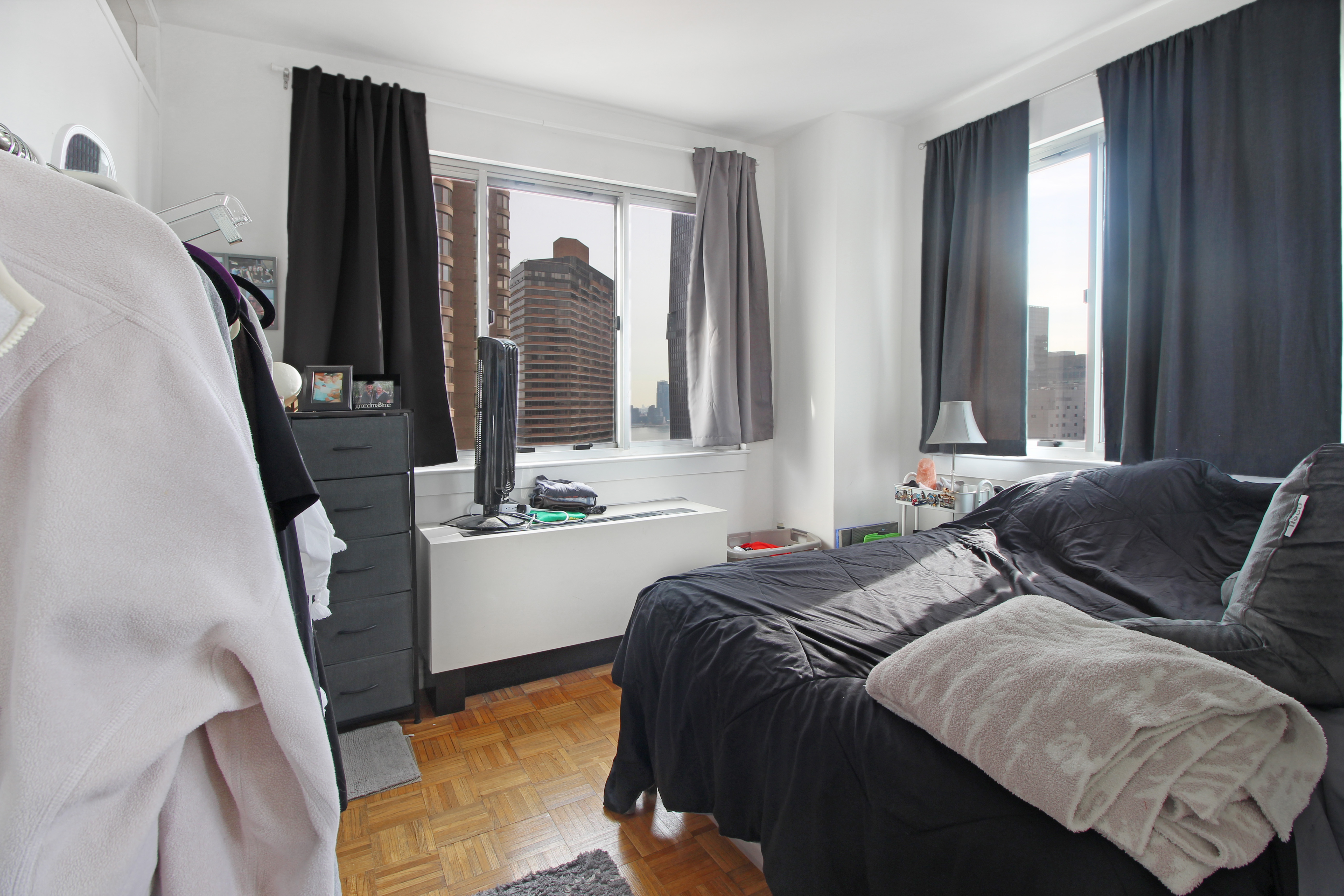 308 East 38th Street, Unit 20A Manhattan, NY 10016 - Photo 13 of 13 a bedroom with a bed and dresser with mirror