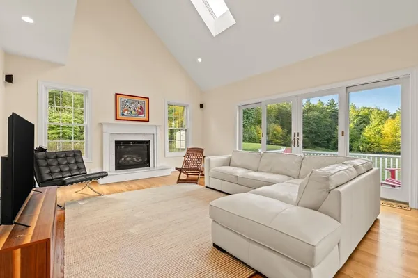 a living room with furniture large window and a fireplace