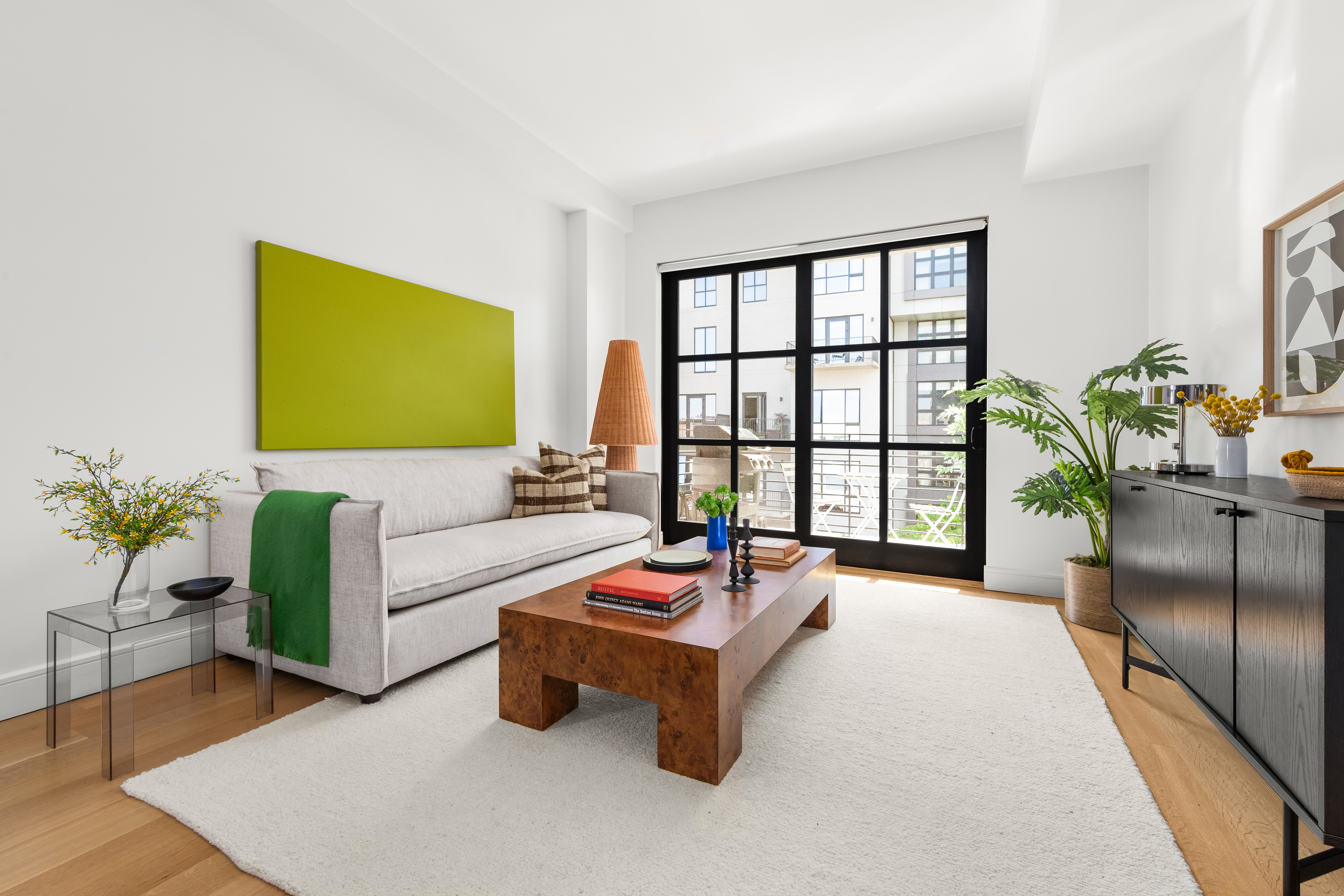 a living room with furniture and a potted plant