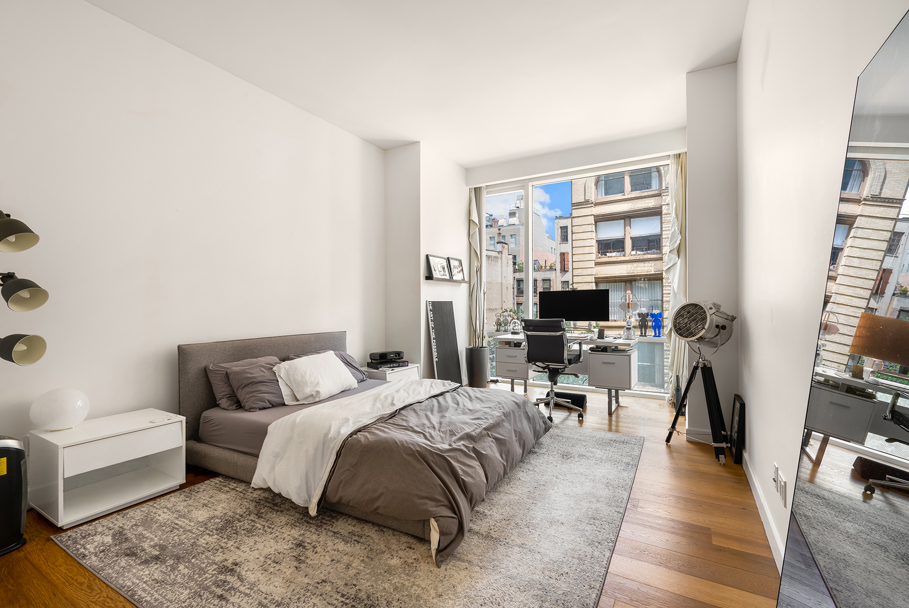 311 West Broadway, Unit 4G Manhattan, NY 10013 - Photo 5 of 8 a bedroom with a bed and a book shelf