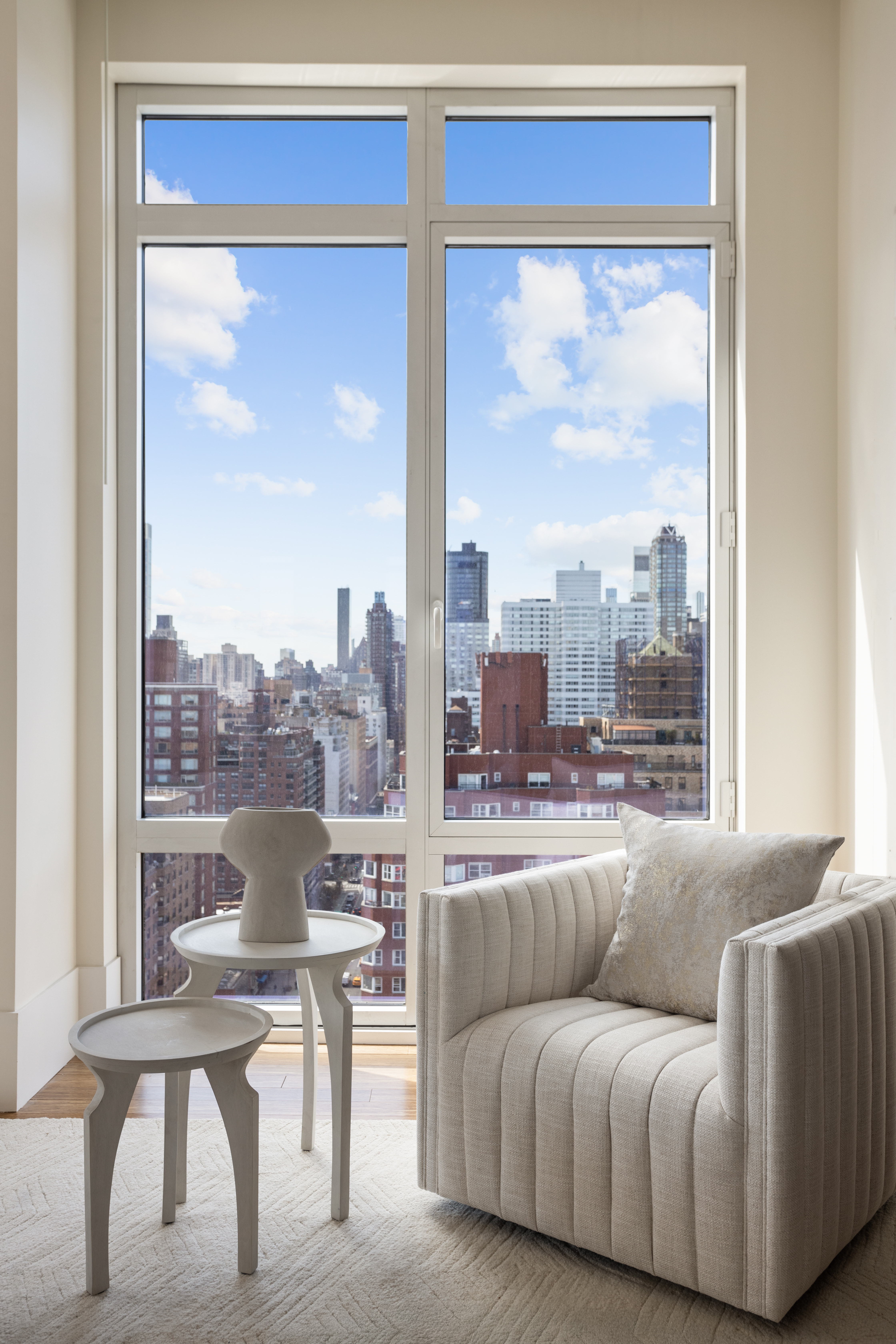 255 East 74th Street, Unit 21B Manhattan, NY 10021 - Photo 2 of 40 a living room with furniture and a window