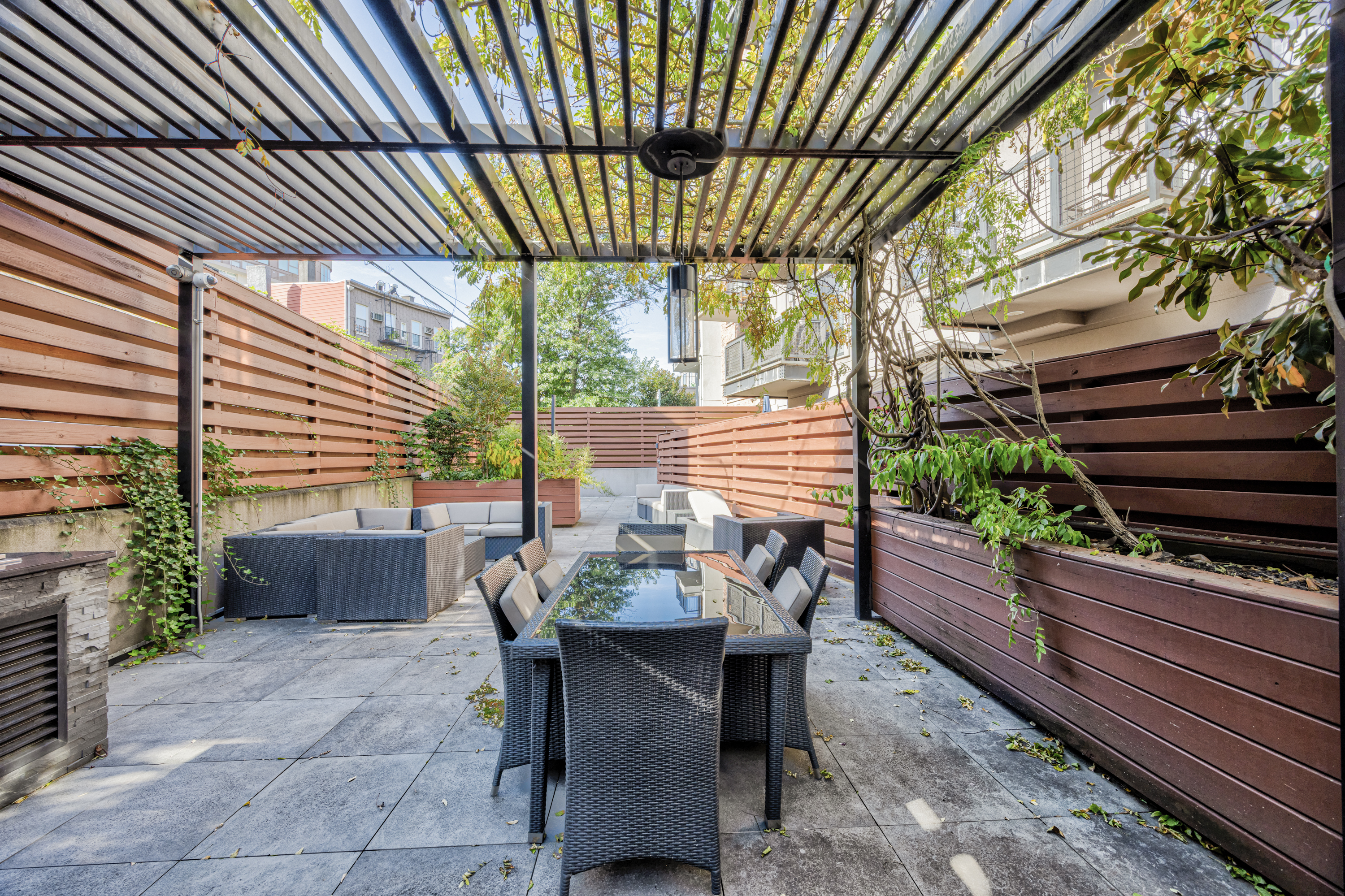 42 Maspeth Avenue, Unit 1D Brooklyn, NY 11211 - Photo 23 of 28 a view of a patio with a table and chairs and potted plants