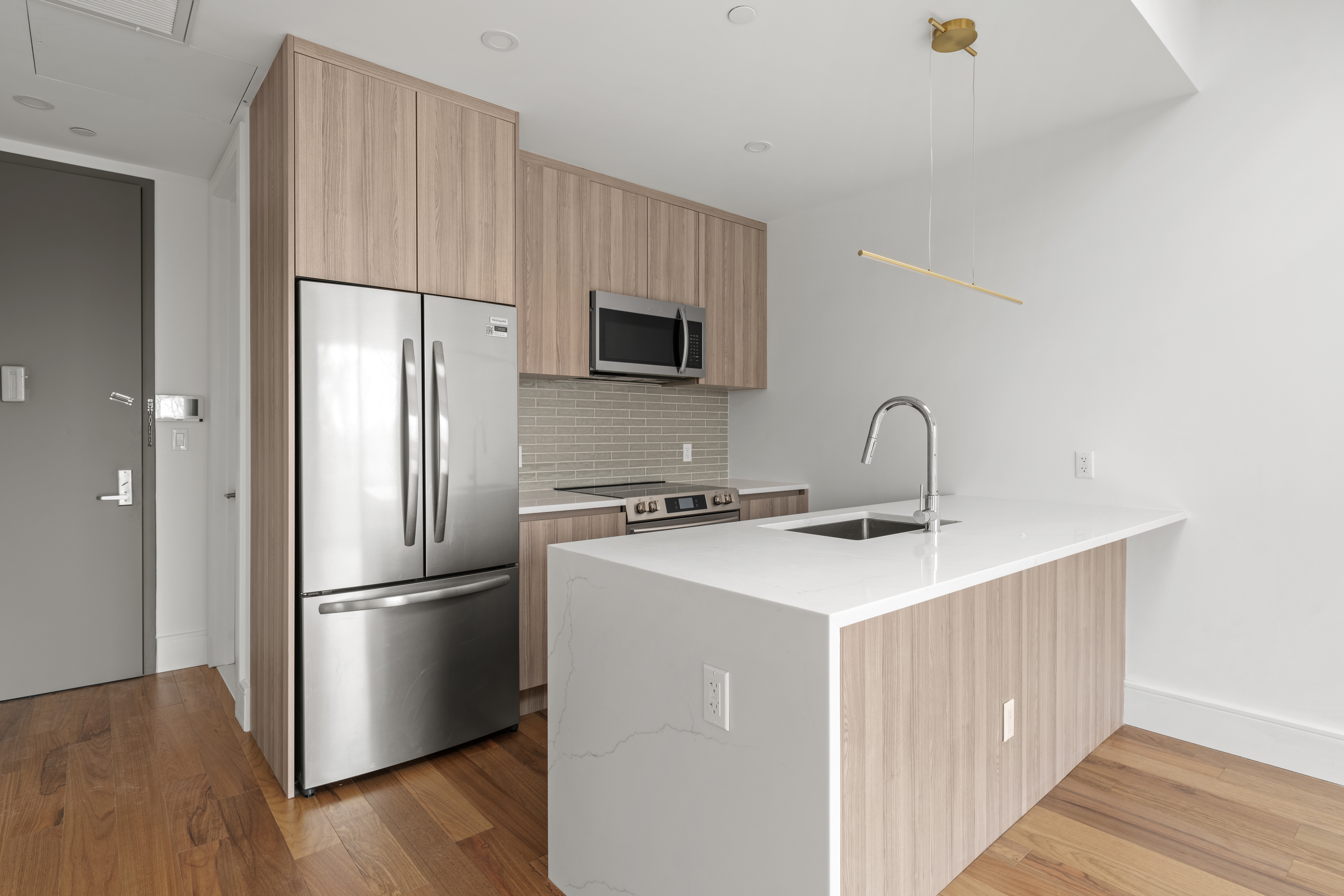 82 Cooper Street, Unit 3A Brooklyn, NY 11207 - Photo 9 of 17 a kitchen with a refrigerator sink and cabinets