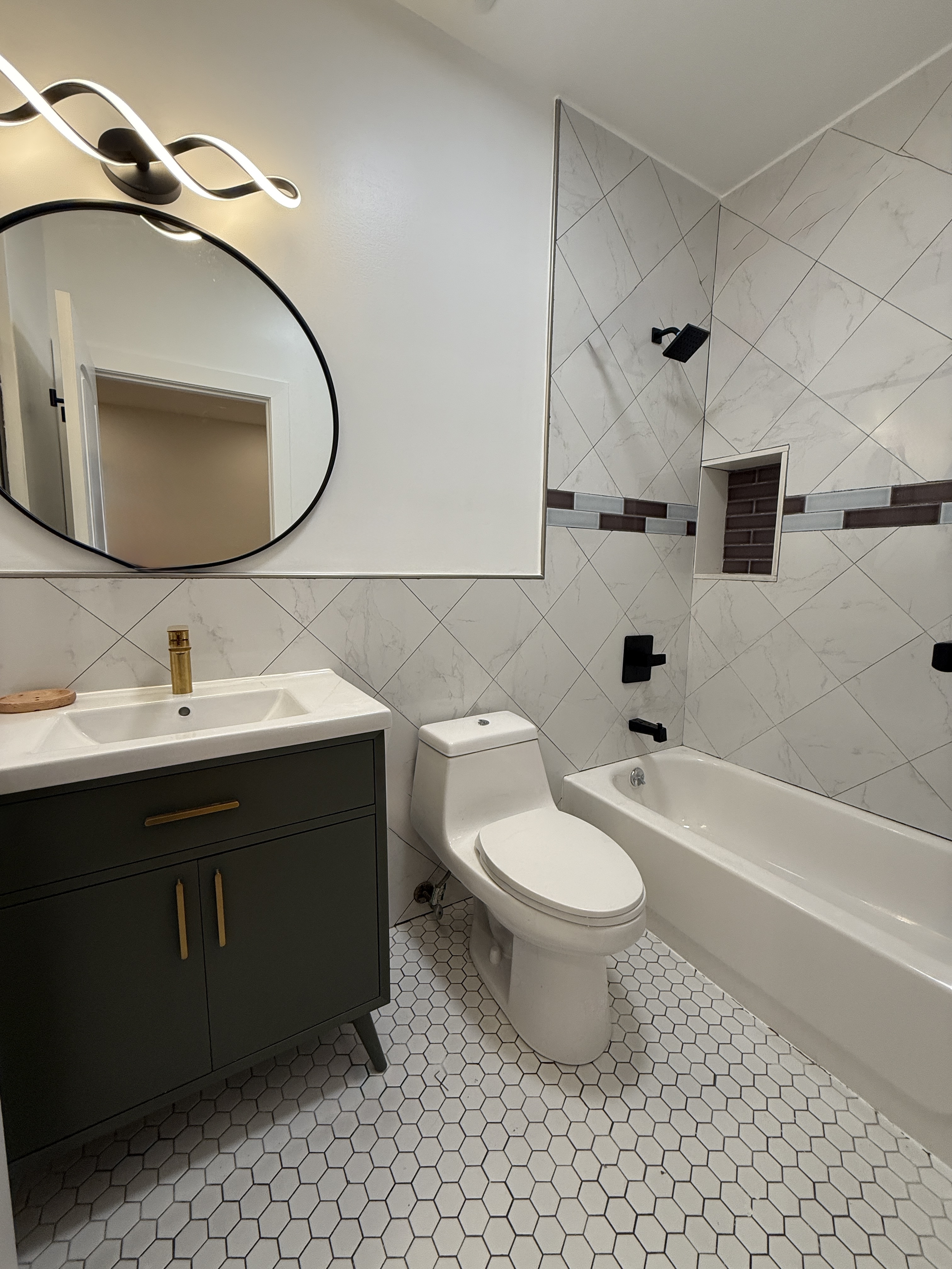 139 Autumn Avenue, Unit 1 Brooklyn, NY 11208 - Photo 6 of 14 a bathroom with a sink toilet and shower