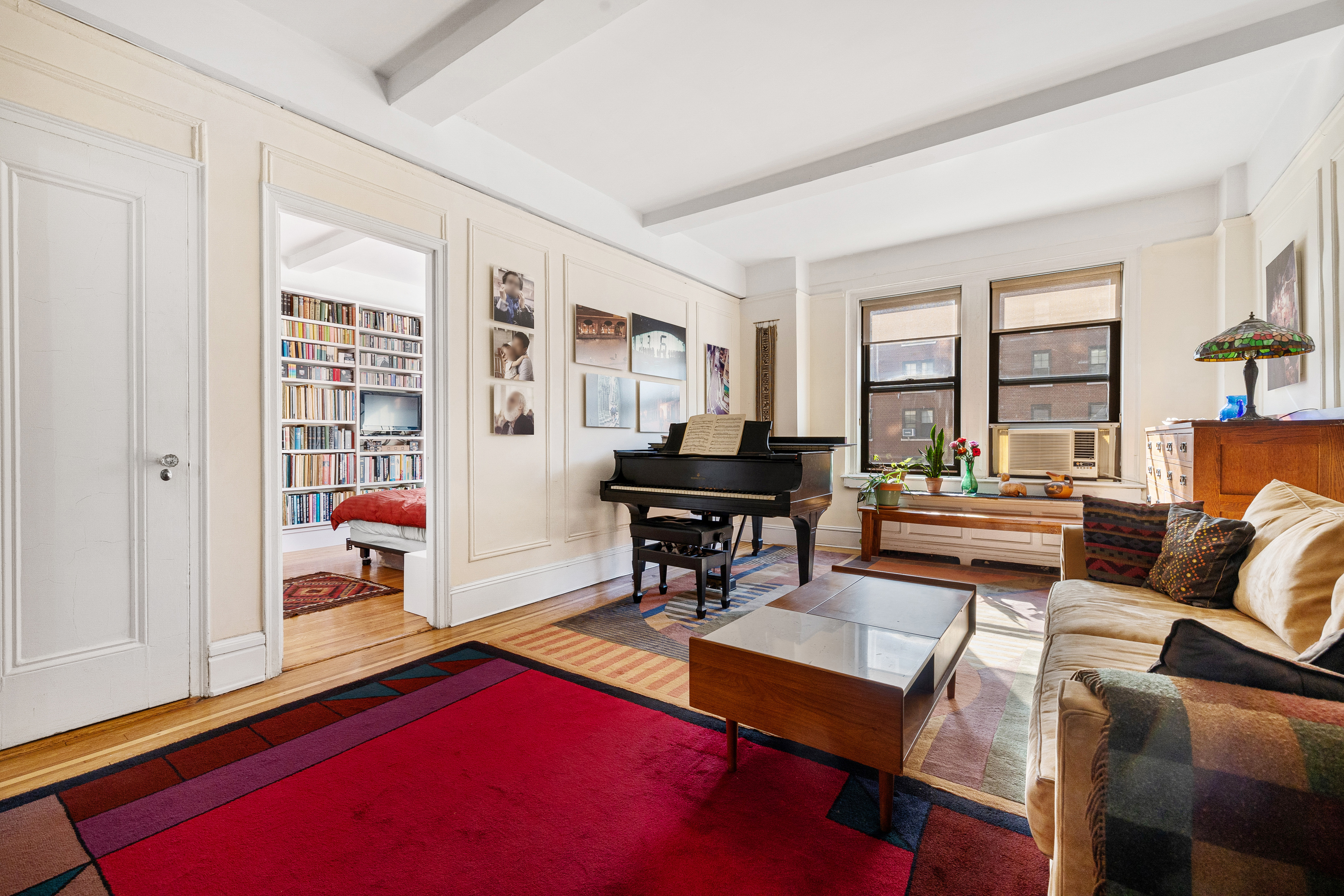 269 West 72nd Street, Unit 9B Manhattan, NY 10023 - Photo 2 of 13 a living room with furniture a table and large window