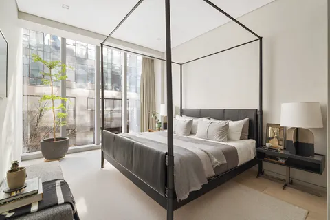 a bedroom with a bed and a large window