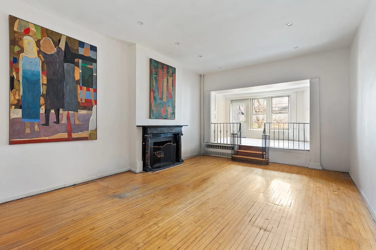 a view of an empty room with glass door and balcony