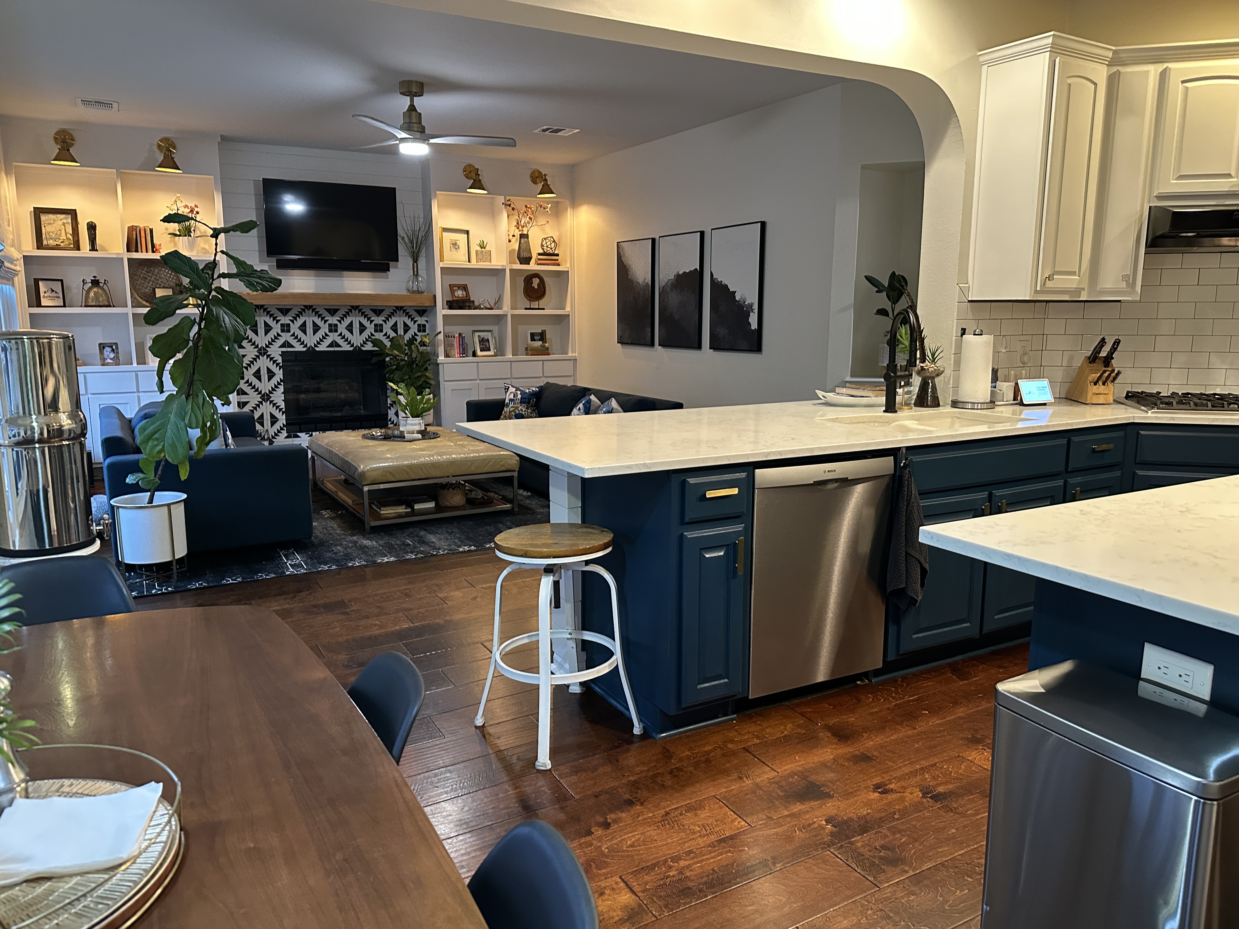 11105 Bexley Lane Austin, TX 78739 - Photo 3 of 12 a kitchen with a sink dishwasher a stove and a dining table with wooden floor