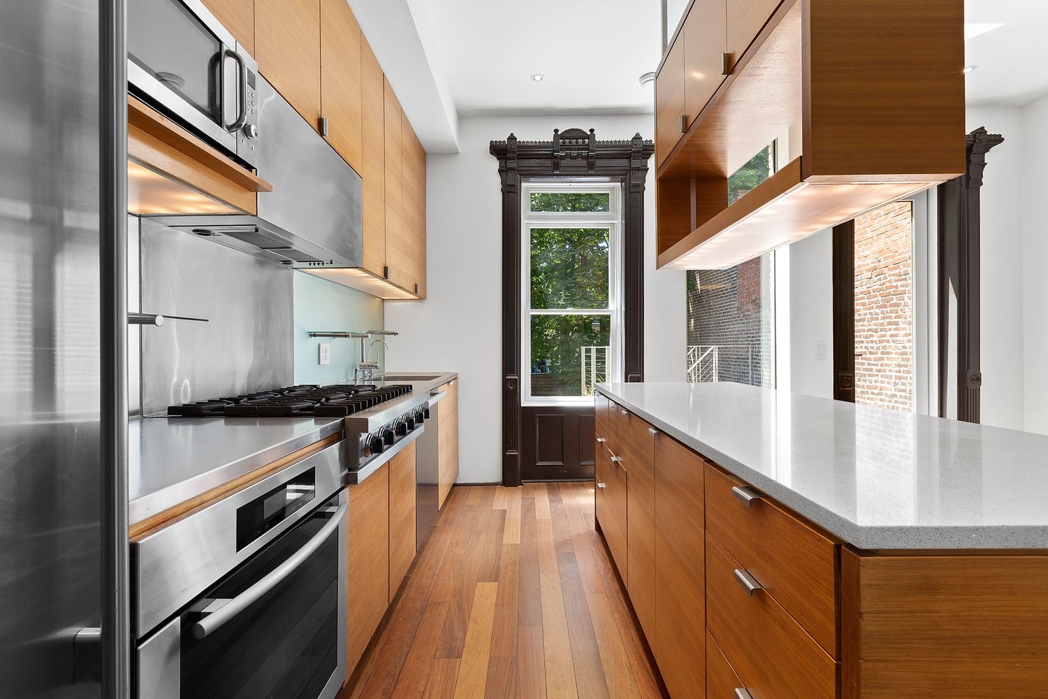 64 Clifton Place, Unit PARLOR Brooklyn, NY 11238 - Photo 5 of 17 a kitchen with stainless steel appliances granite countertop a stove and a sink