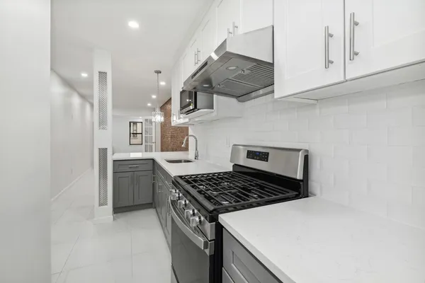 a kitchen with stainless steel appliances granite countertop a stove and a refrigerator