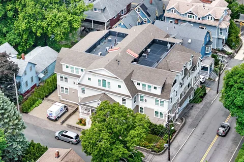 an aerial view of multiple houses with yard