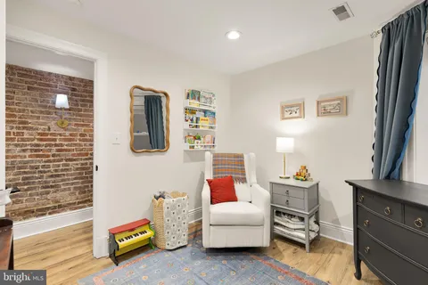 a bedroom with furniture and a flat screen tv