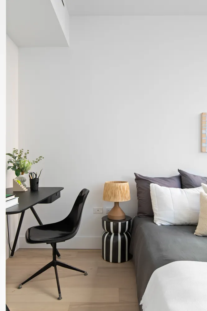 a living room with furniture and a lamp