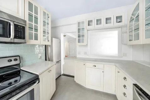 a kitchen with cabinets and appliances