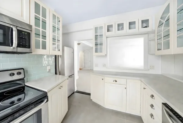 a kitchen with cabinets and appliances