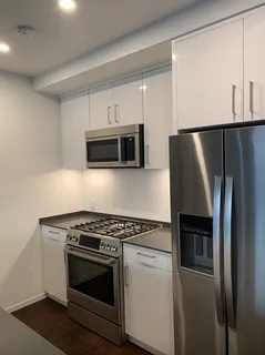a kitchen with stainless steel appliances a stove a microwave and a refrigerator