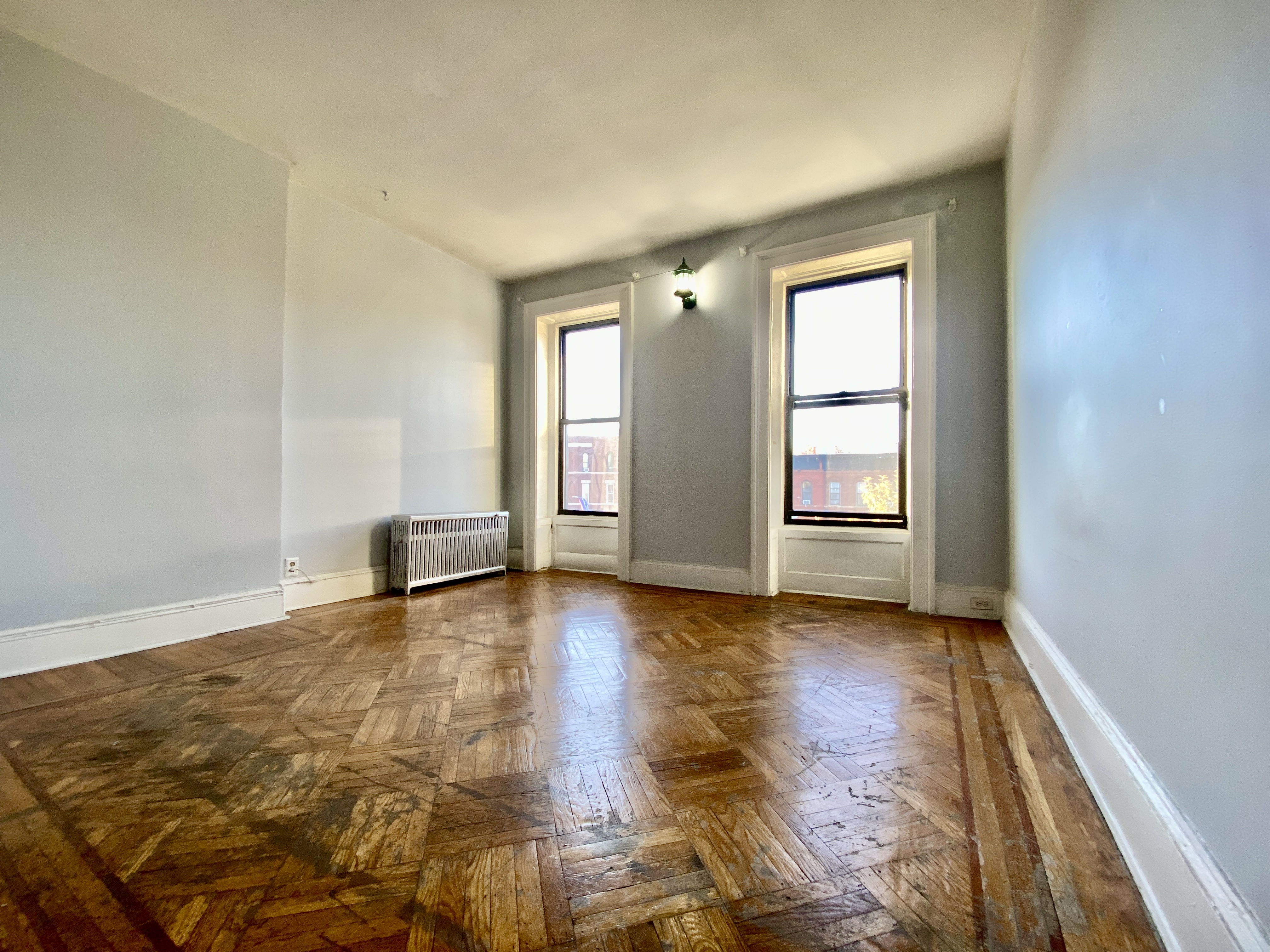 699 4th Avenue, Unit 3 Brooklyn, NY 11232 - Photo 1 of 8 an empty room with wooden floor and windows