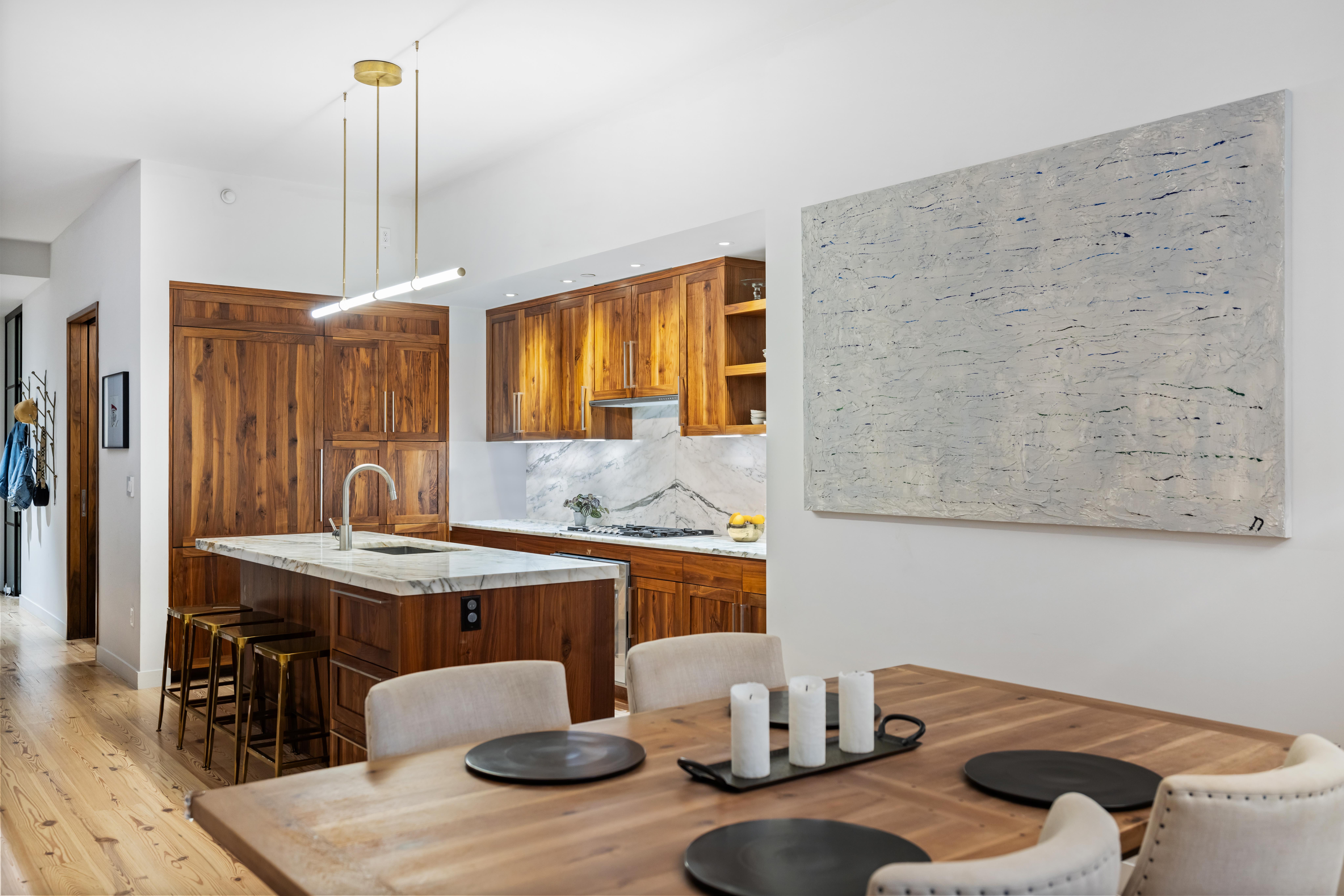 130 Furman Street, Unit S102 Brooklyn, NY 11201 - Photo 6 of 26 a kitchen with a table and chairs