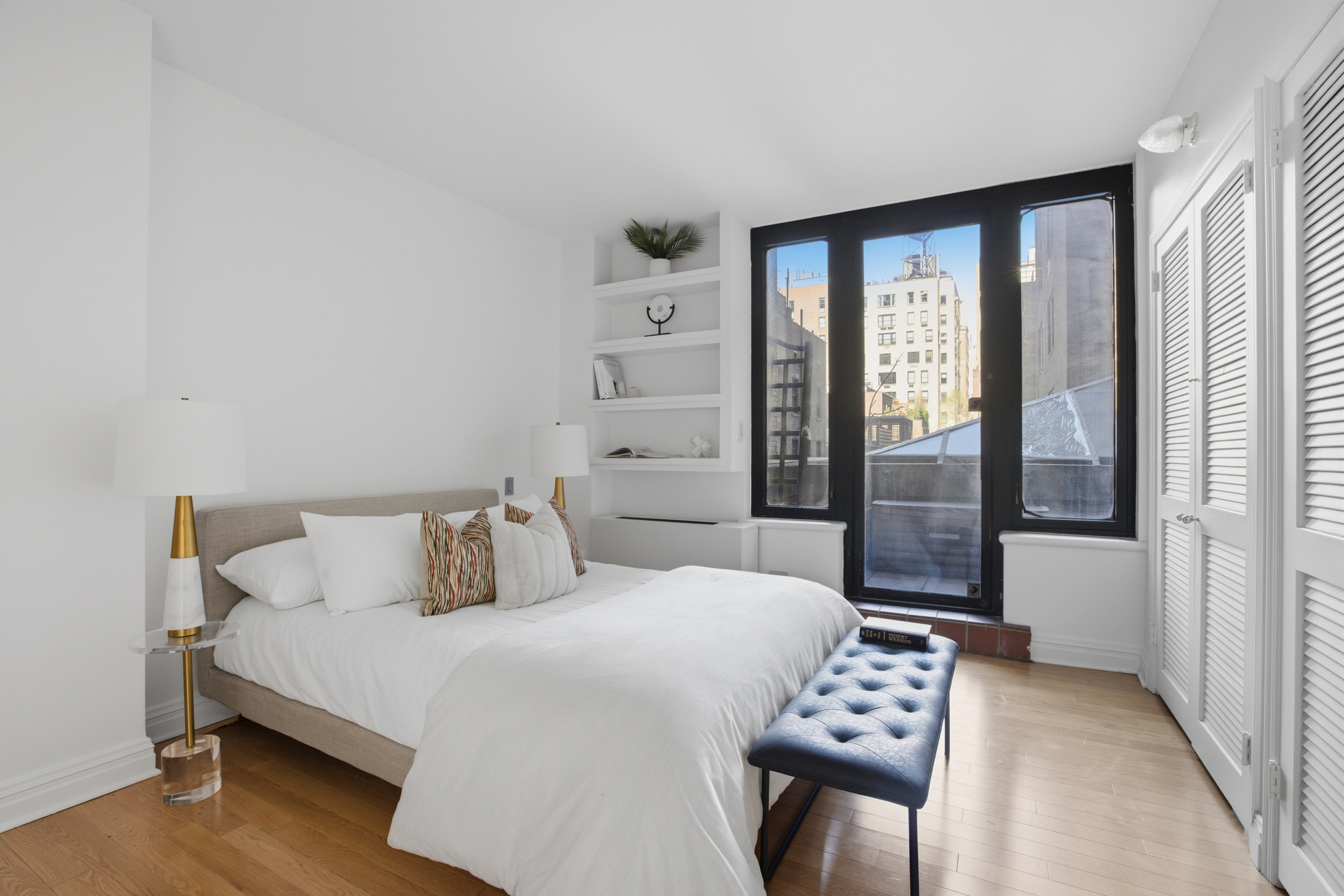 188 East 70th Street, Unit 3A Manhattan, NY 10021 - Photo 11 of 18 a bedroom with a large bed and a window