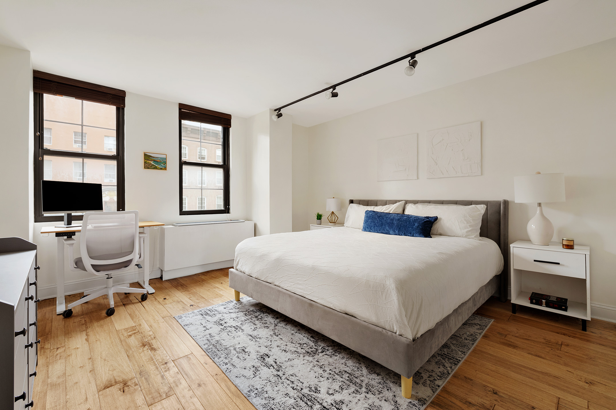 222 West 14th Street, Unit 3N Manhattan, NY 10011 - Photo 3 of 9 a bedroom with a bed and a flat screen tv