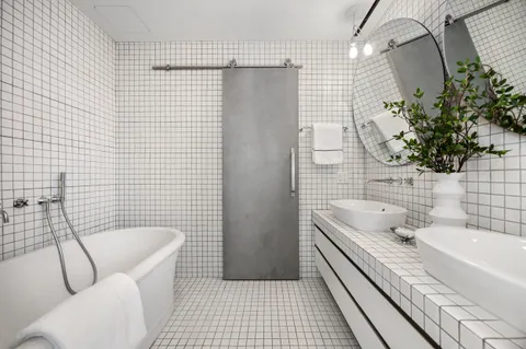 a bathroom with a granite countertop sink a toilet and shower