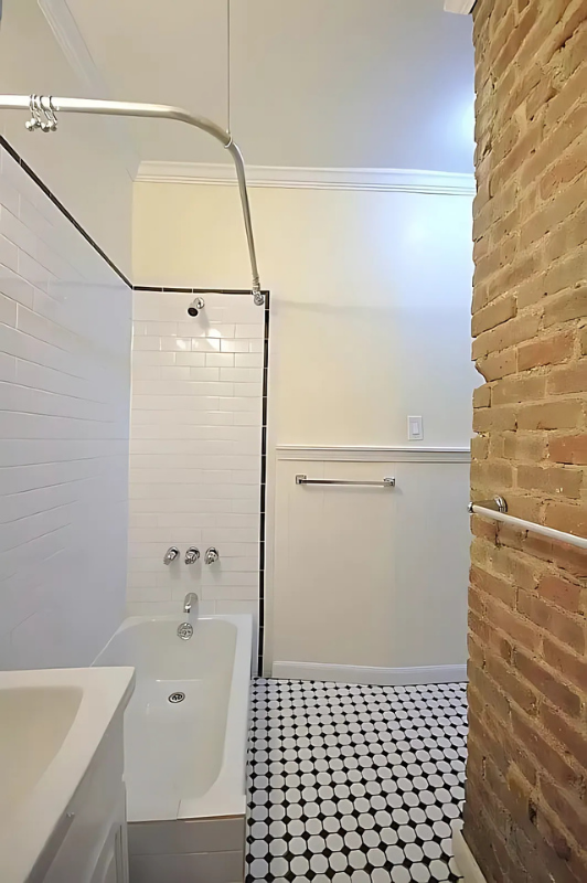 1273 1st Avenue, Unit 8 Manhattan, NY 10065 - Photo 6 of 6 a bathroom with a shower and a tub