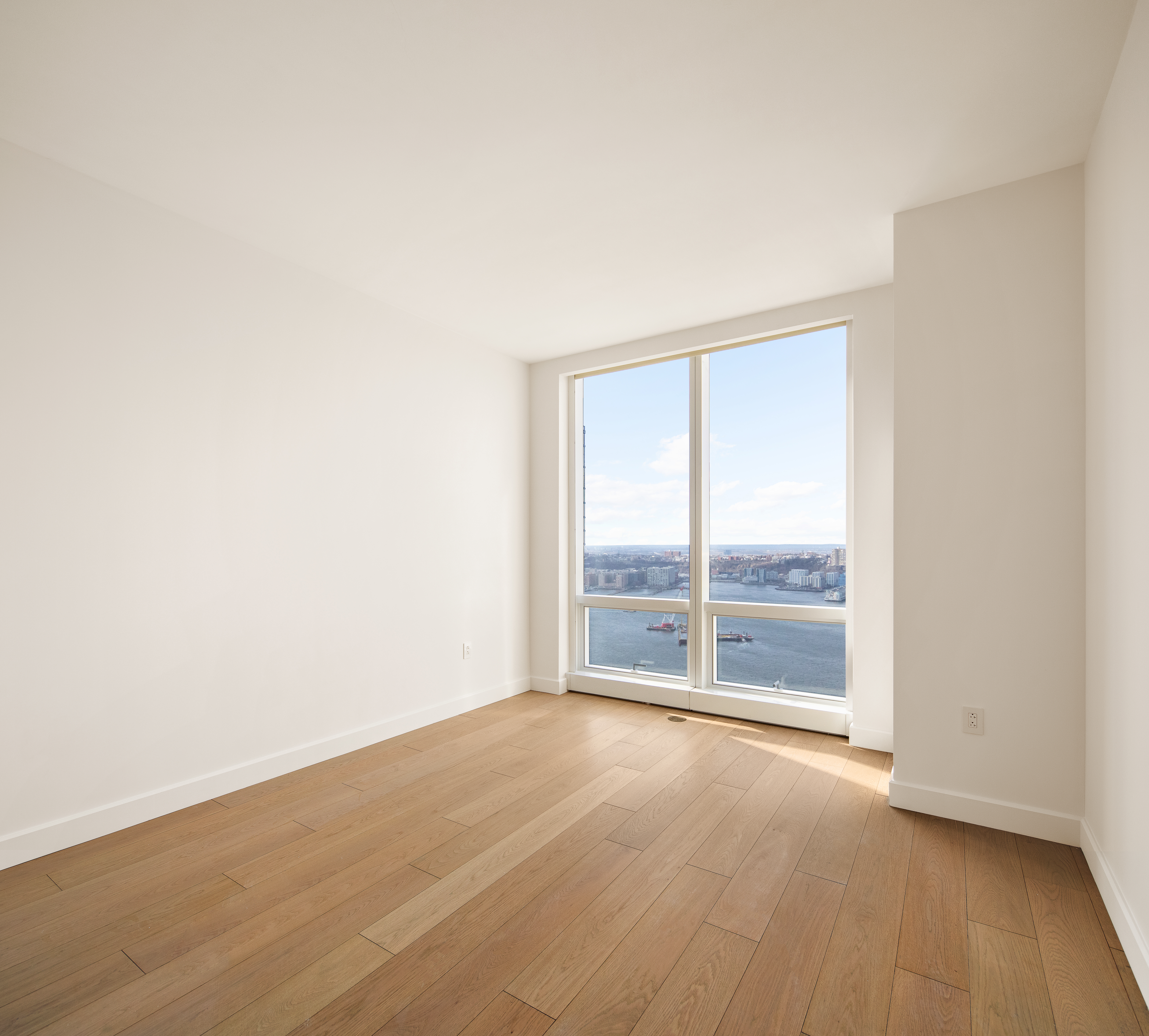15 Hudson Yards, Unit 37F Manhattan, NY 10001 - Photo 6 of 8 an empty room with wooden floor and windows