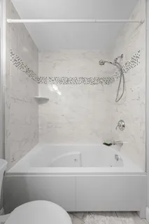 a bathroom with a bathtub and a shower