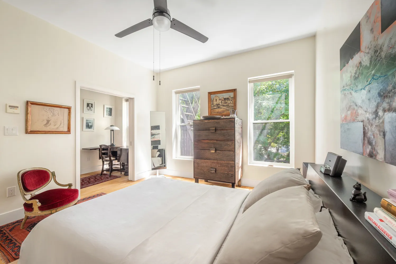 a bedroom with a bed and dresser with mirror