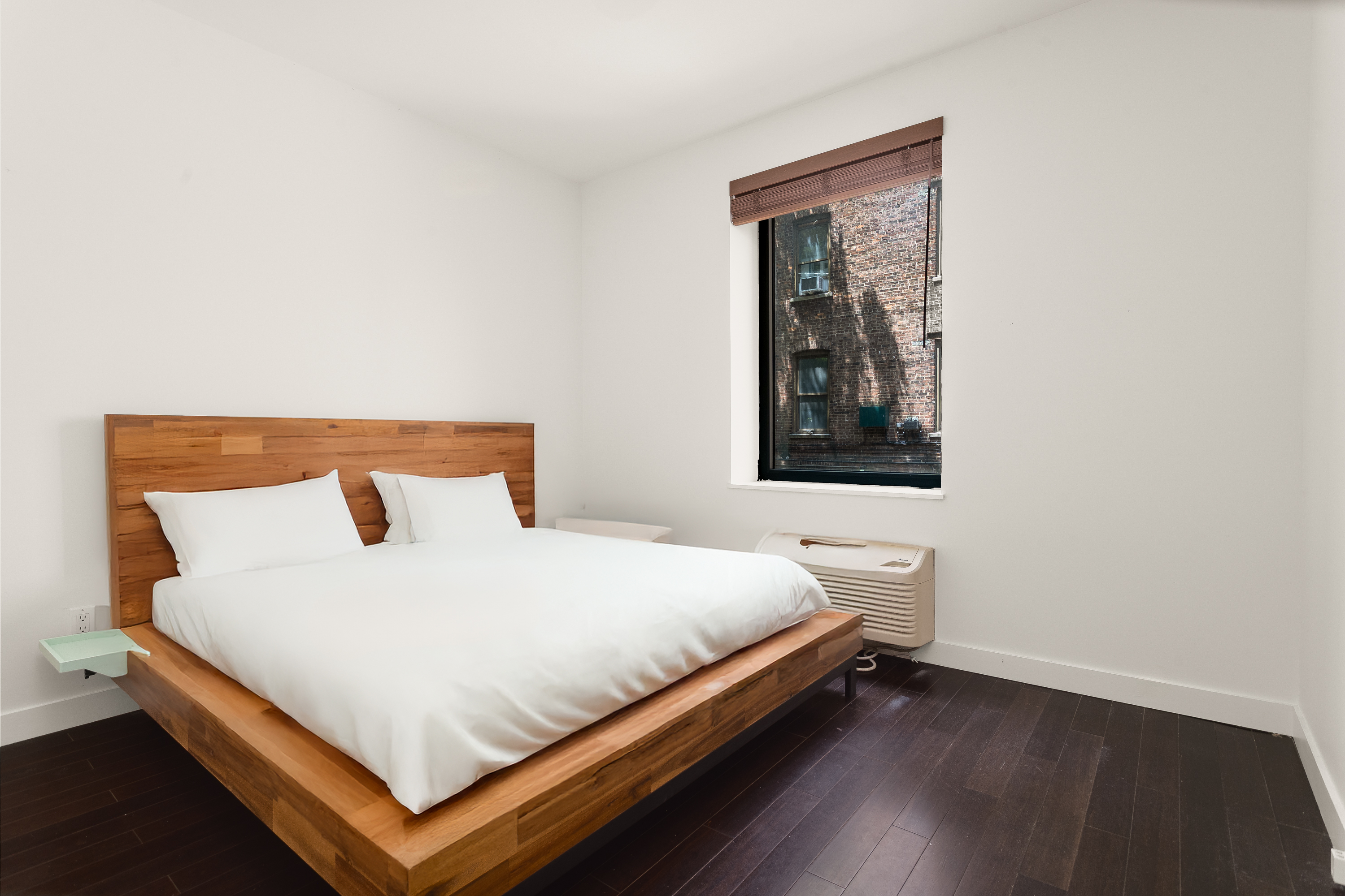 753 St Nicholas Avenue, Unit 2B Manhattan, NY 10031 - Photo 6 of 10 a bedroom with a bed and wooden floor