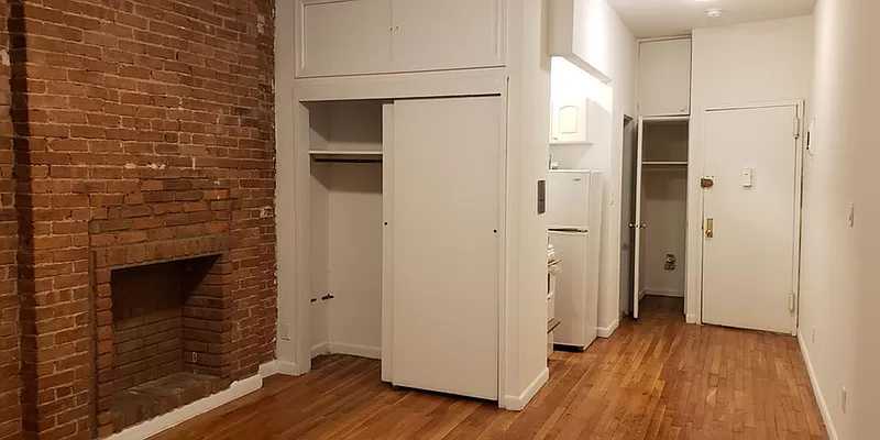 1734 2nd Avenue, Unit 1D Manhattan, NY 10128 - Photo 3 of 5 a view of hallway with wooden floor and stairs
