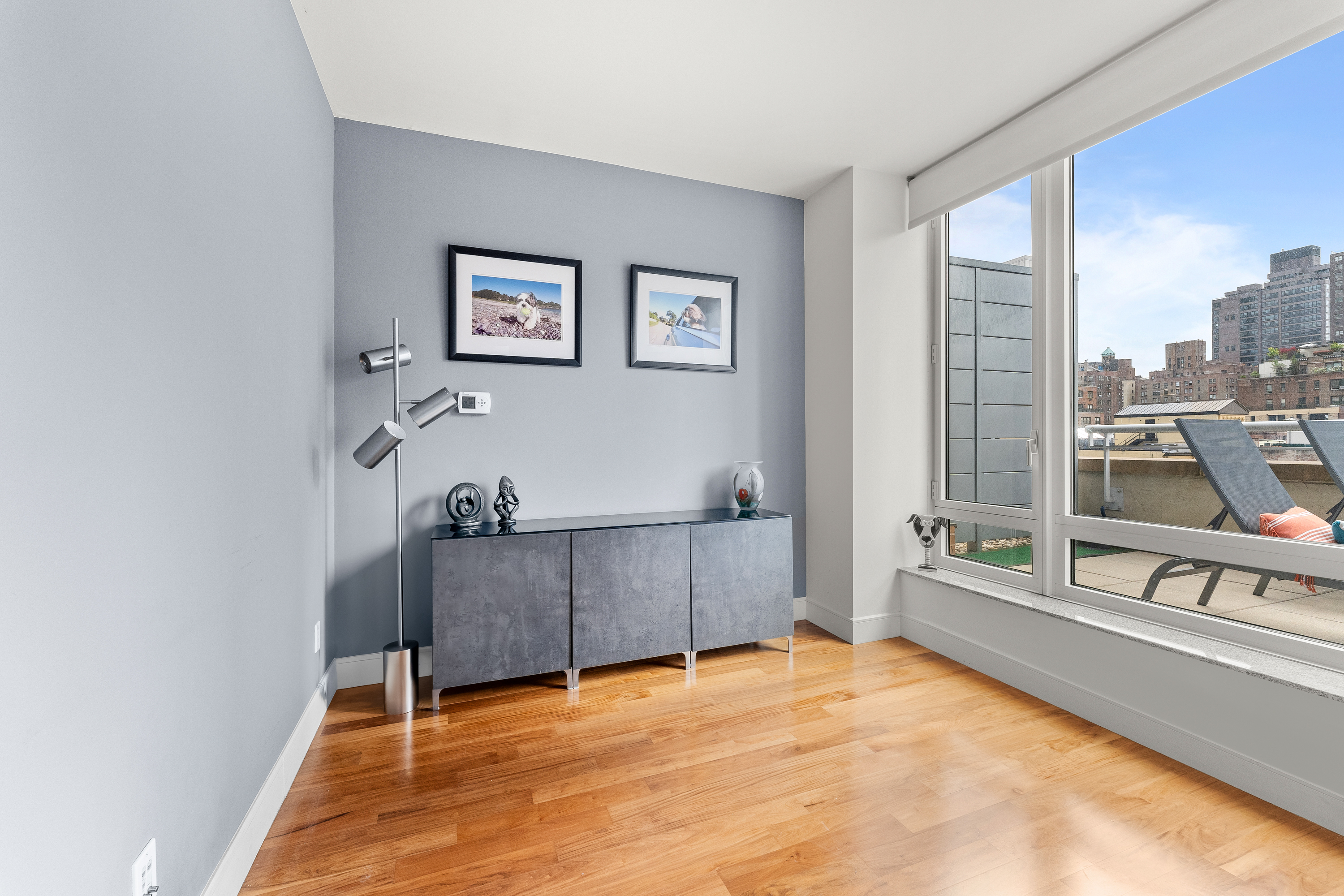 250 East 53rd Street, Unit 903 Manhattan, NY 10022 - Photo 4 of 8 a view of a room with furniture and window