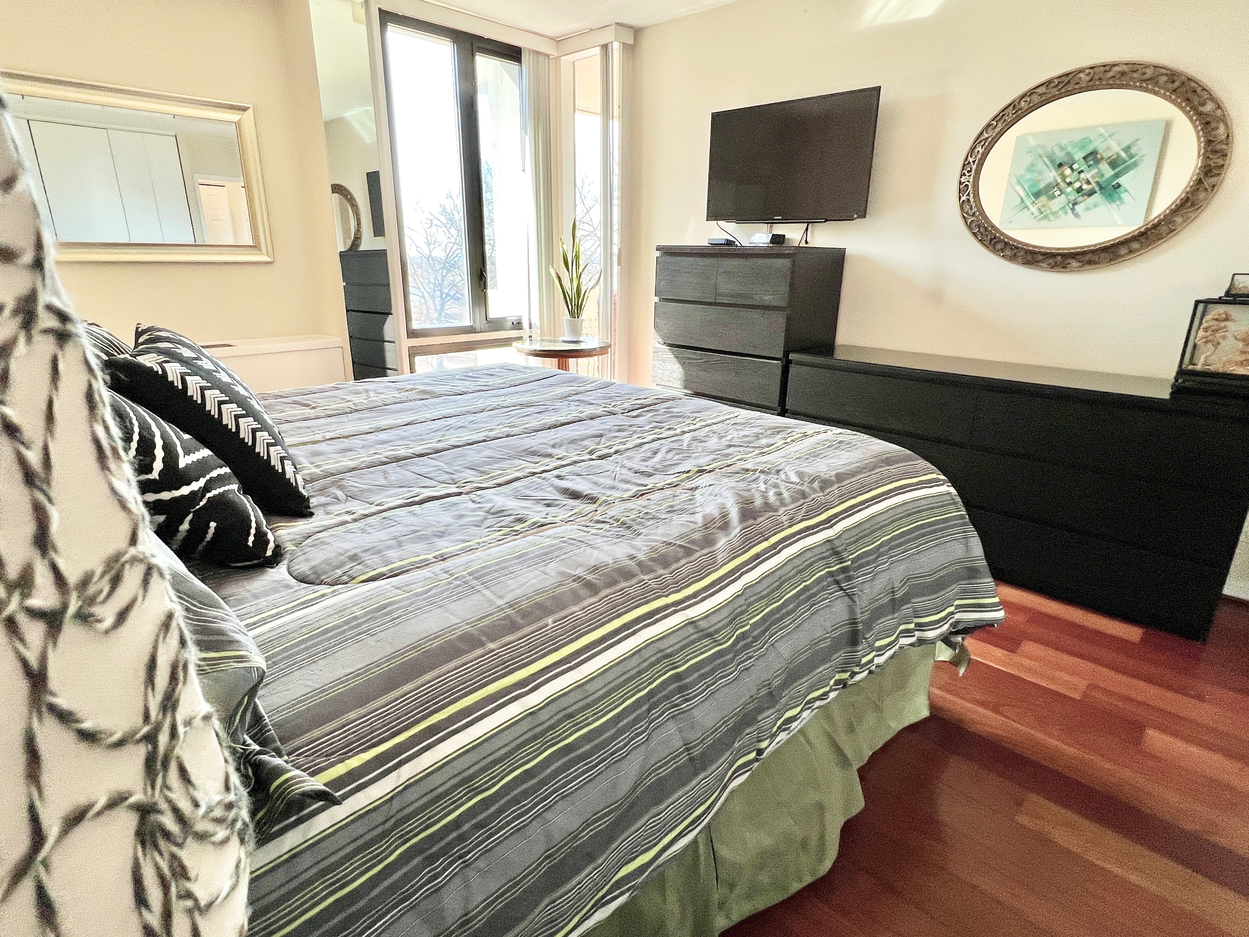 490 M Street Southwest, Unit W304 Washington, DC 20024 - Photo 17 of 36 a bedroom with a bed and a chandelier