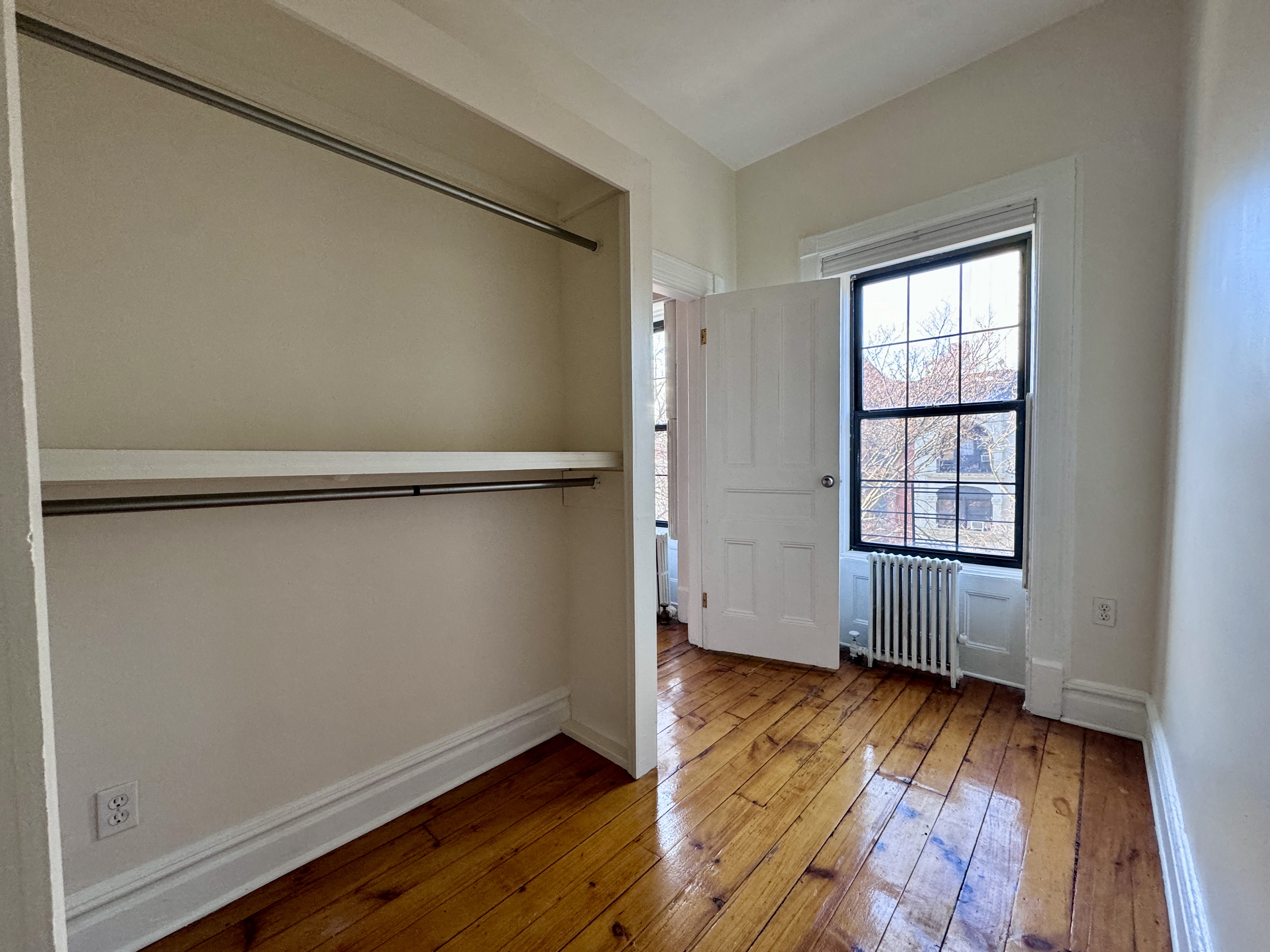 15 Arlington Place, Unit 3 Brooklyn, NY 11216 - Photo 11 of 14 a view of an empty room with wooden floor and a window