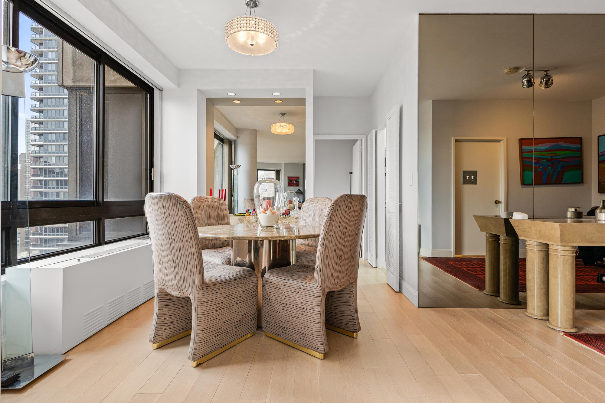 167 East 61st Street, Unit 20E Manhattan, NY 10065 - Photo 13 of 24 a view of a dining room with furniture and a window