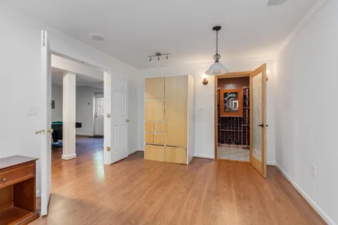 a view of a room with wooden floor and a window