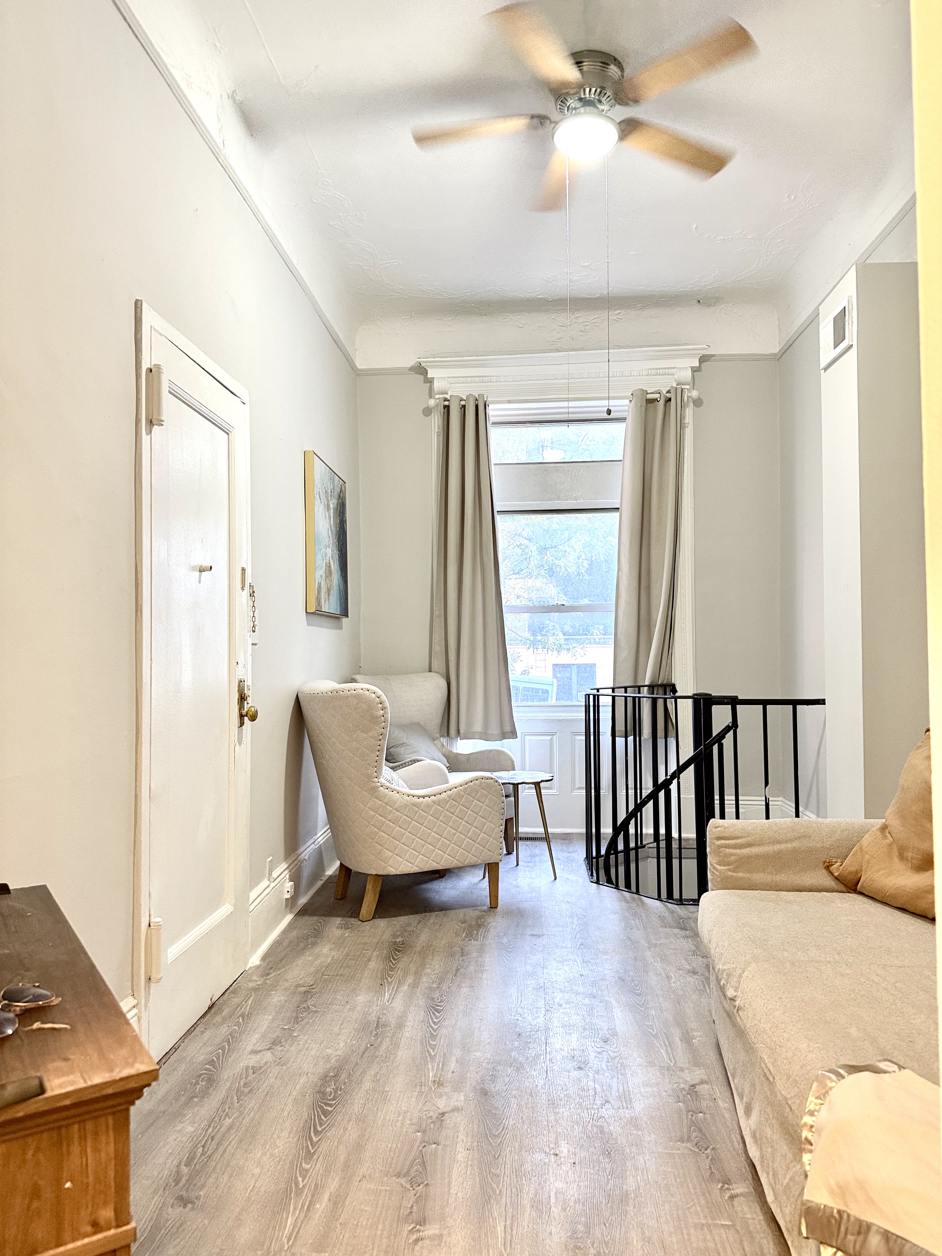 611 West 145th Street Manhattan, NY 10031 - Photo 2 of 3 a spacious bedroom with a bed and a chandelier