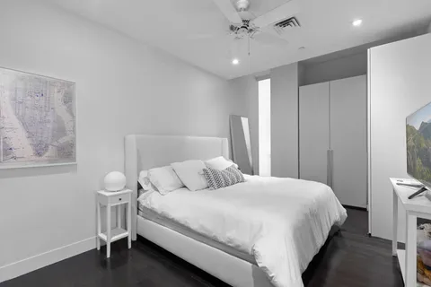 a living room with furniture and a baby crib
