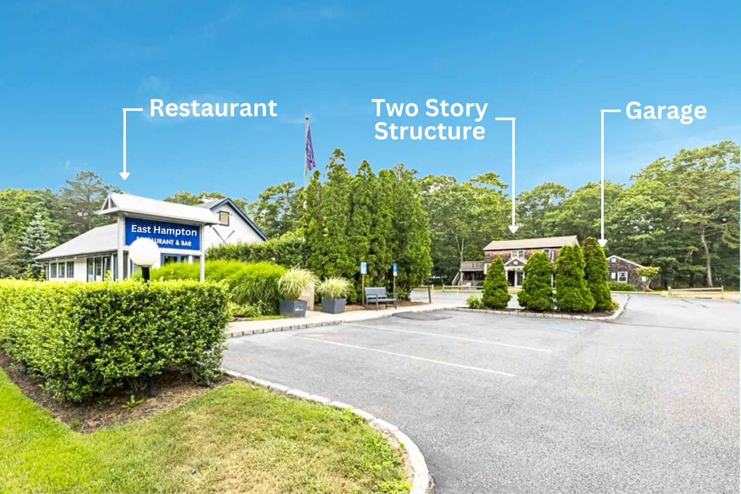 a view of a building with potted plants and a large parking space