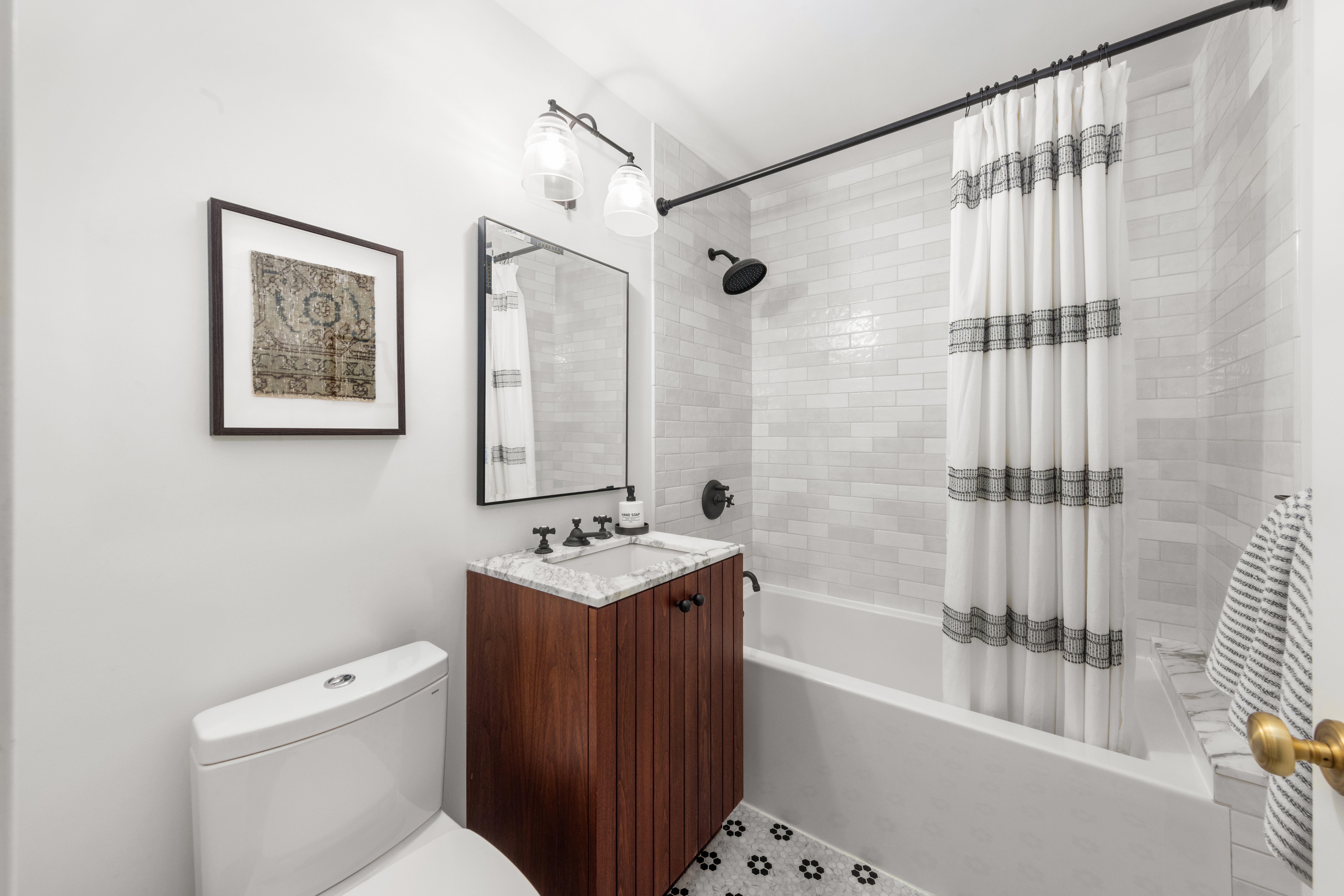 135 East 83rd Street, Unit 8/9C Manhattan, NY 10028 - Photo 10 of 15 a bathroom with a toilet a sink and bathtub