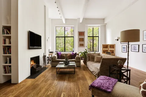 a living room with furniture fireplace and a flat screen tv