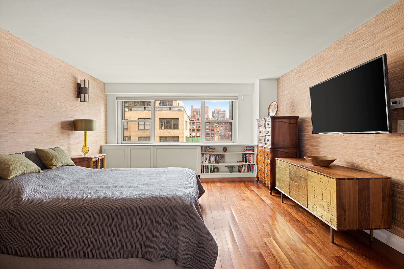 330 East 49th Street, Unit 12E Manhattan, NY 10017 - Photo 8 of 16 a bedroom with a bed and a flat screen tv