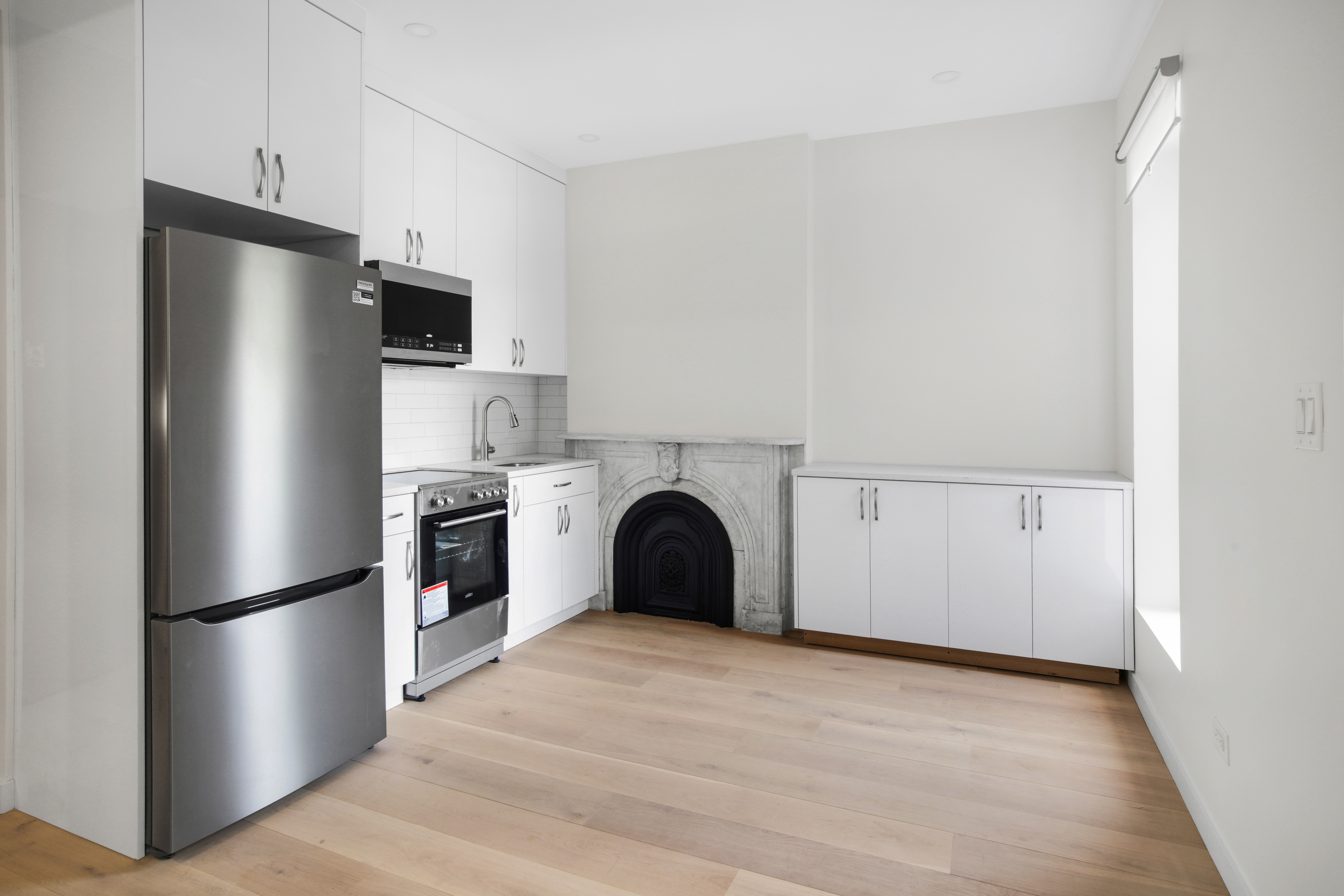 94 6th Avenue, Unit 3R Brooklyn, NY 11217 - Photo 6 of 12 a view of kitchen with stainless steel appliances wooden floor and a window